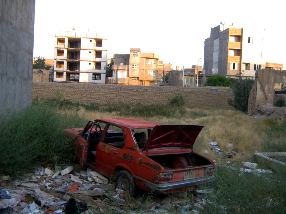 Destroyed red car in a abandoned zone nearnear amin eslami garden- Nishapur 5