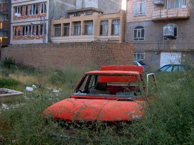 Destroyed red car in a abandoned zone nearnear amin eslami garden- Nishapur 6