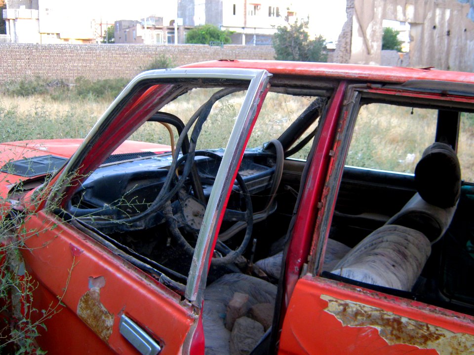 Destroyed red car in a abandoned zone nearnear amin eslami garden- Nishapur 1