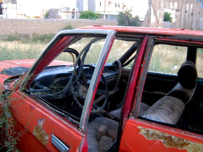 Destroyed red car in a abandoned zone nearnear amin eslami garden- Nishapur 1