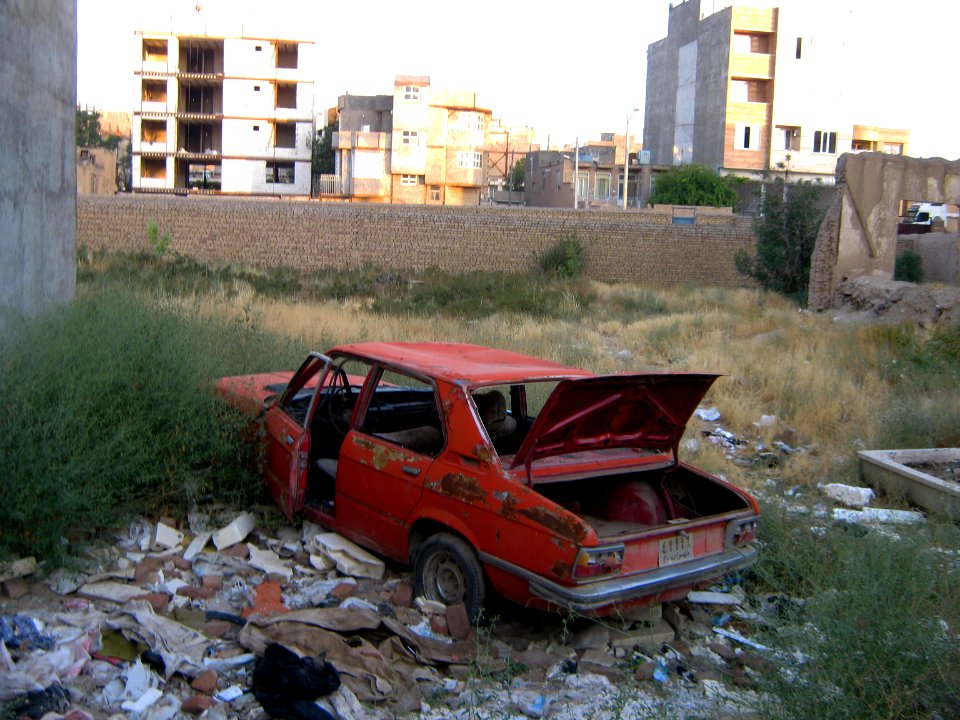 Destroyed red car in a abandoned zone nearnear amin eslami garden- Nishapur 7