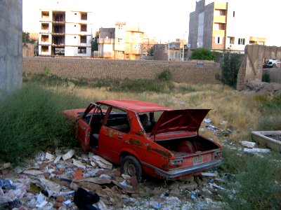 Destroyed red car in a abandoned zone nearnear amin eslami garden- Nishapur 7
