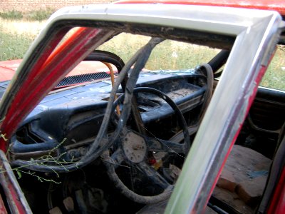 Destroyed red car in a abandoned zone nearnear amin eslami garden- Nishapur 4