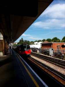 Dollis Hill tube station, platform with train photo