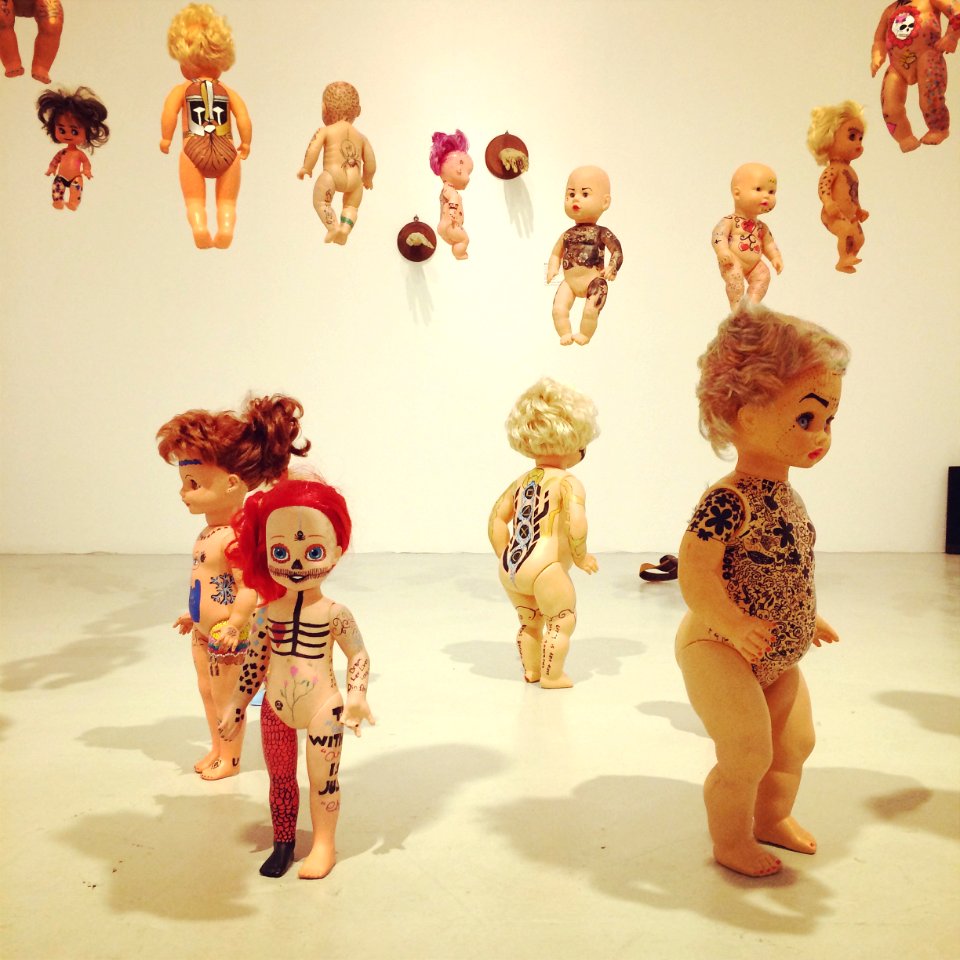 Dolls with tattoos art installation at Brandts
