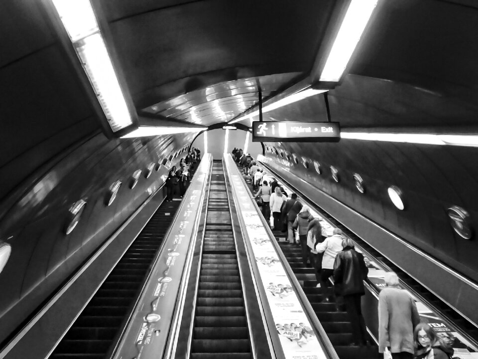 Underground escalator passengers photo