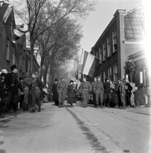 Domburg. Koningin Wilhelmina loopt door de Weststraat. Links de commissaris der…, Bestanddeelnr 900-4062