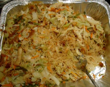 Dinner dish at a party in a silver pan with a fork