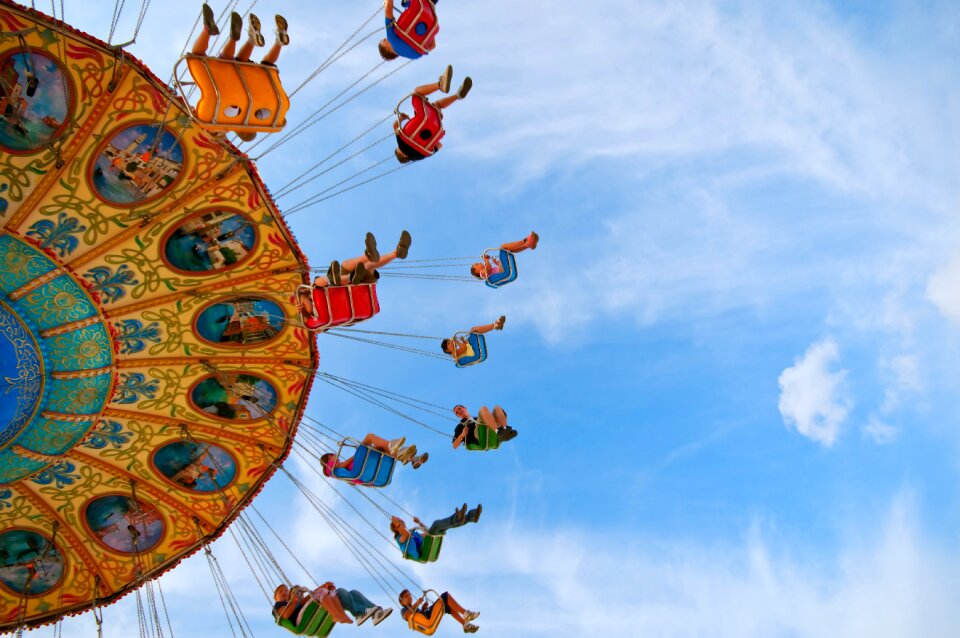 Amusement park swing blue sky