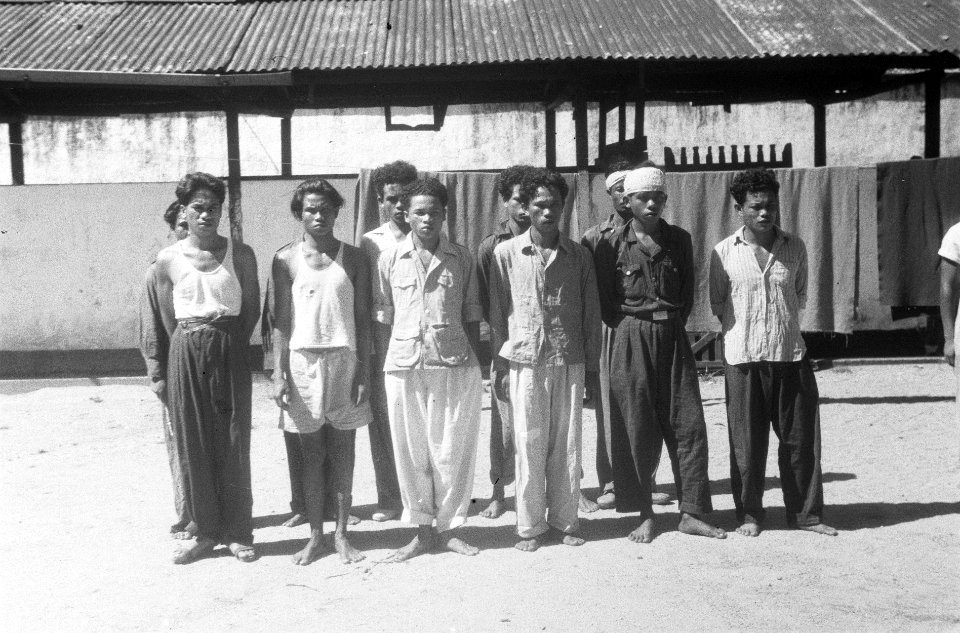 Elf Indonesische mannen in diverse uniformen staan opgesteld op een ommuurde bin, Bestanddeelnr 5370