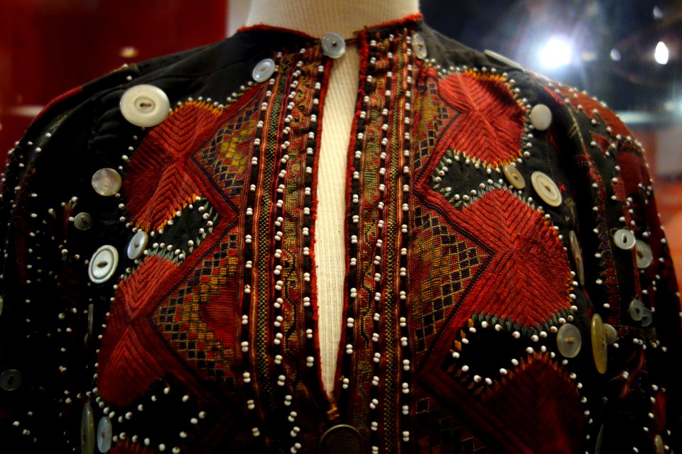 Embroidered dress, view 1, Kohistan, Northwest Frontier Province, Pakistan, early 20th century, cotton, silk, glass, plastic, silver, brass - Fernbank Museum of Natural History - DSC00129