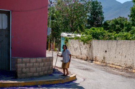 Elderly woman walking by Tuey