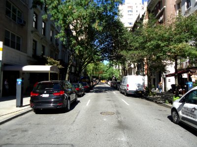 East side of Manhattan street looking west with trees and cars
