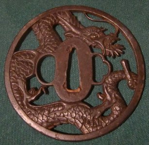 Echizen Kinai school round sword guard with pierced dragon, late 17th century, iron