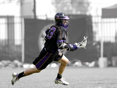 Lacrosse player running stick
