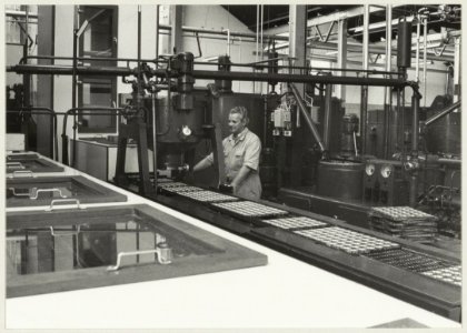 Een kijkje in de Unionfabriek waar aan de lopende band chocolaatjes worden gegoten. NL-HlmNHA 54011547