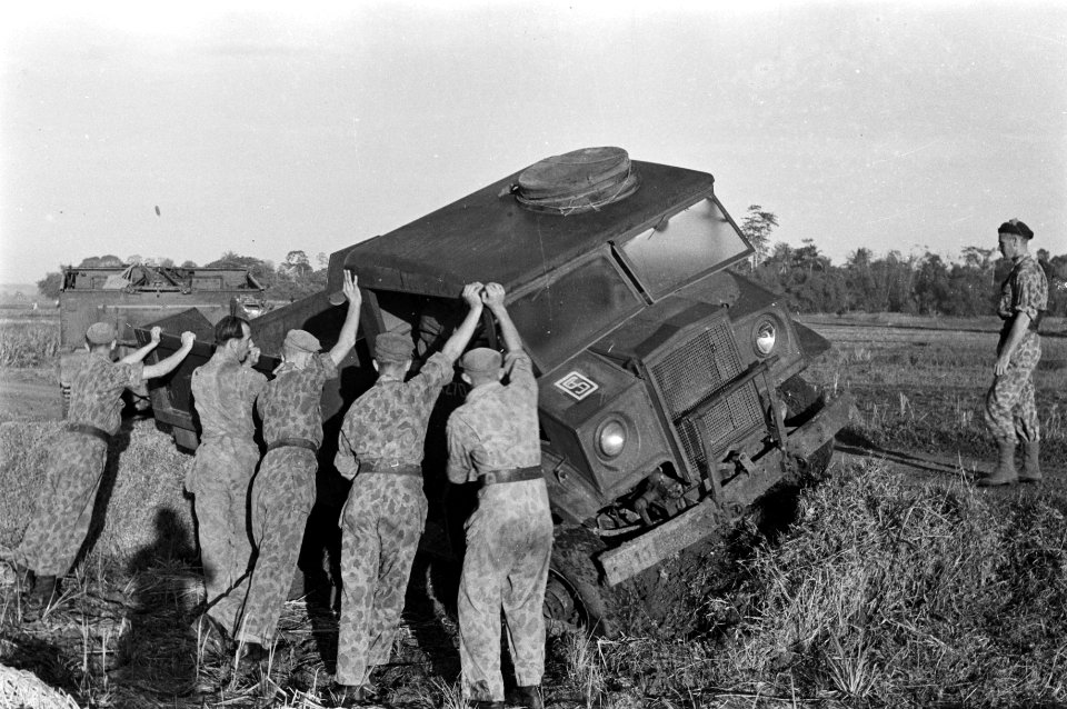 Een legertruck is van de weg geraakt en zit vast in een berm. Met vereende krach, Bestanddeelnr 12048