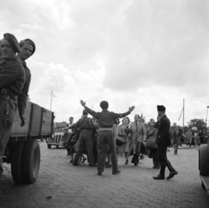 Een militair probeert burgers tegen te houden die naar een vrachtwagen lopen, Bestanddeelnr 900-6224
