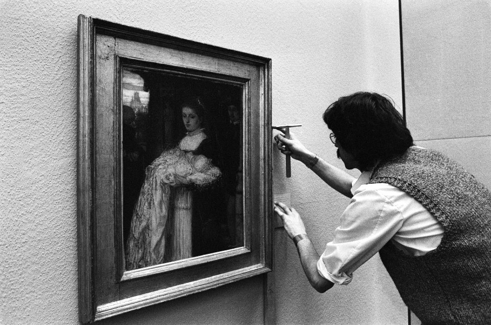 Een medewerker is bezig met het inrichten van de tentoonstelling, Bestanddeelnr 930-1572
