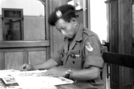 Een KNIL-militair van een Eskadron Vechtwagens leest tijdschriften, Bestanddeelnr 370