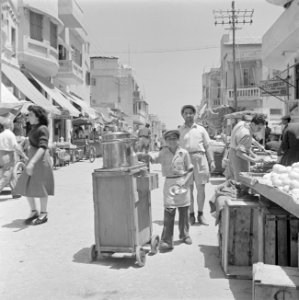 Een straat in Jaffa met winkels, straathandelaar met een karretje en winkelend p, Bestanddeelnr 255-1305 photo