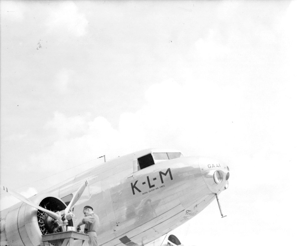 Een vliegtuigmonteur werkt aan de stuurboordmotor van de KLM Douglas DC-2 PH-AKG, Bestanddeelnr 254-6162