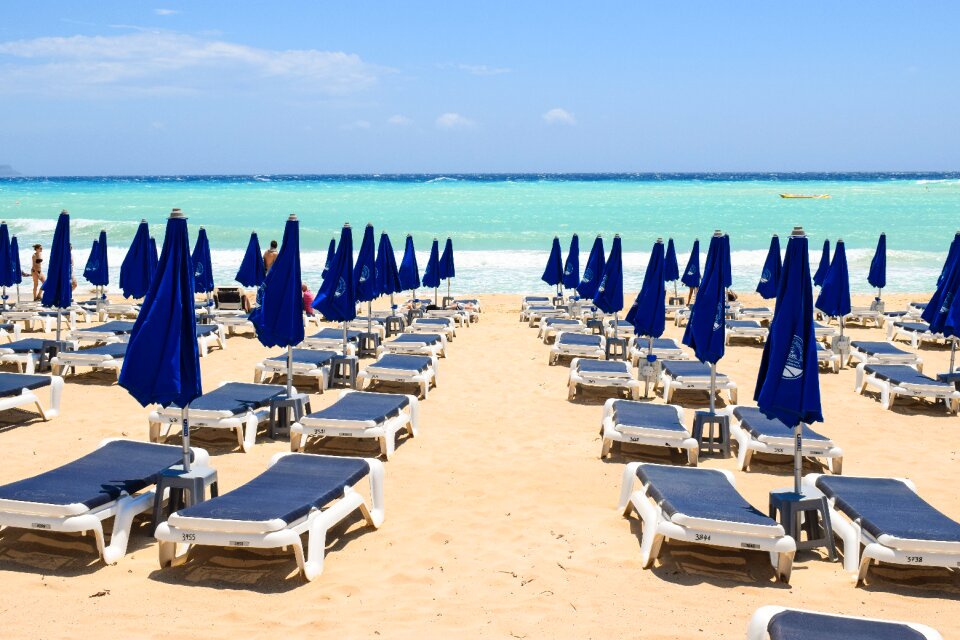 Sand sunbeds umbrellas