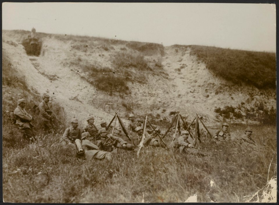 Eenheid van Duitse militairen rust in het gras terwijl er één op de uitkijk staa, Bestanddeelnr 158-2012