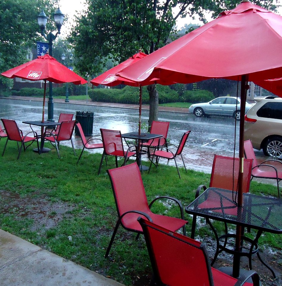 Edison NJ outside The Coffee House pouring rain red umbrellas and chairs