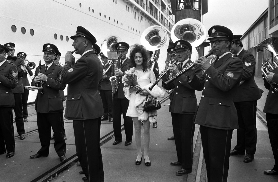 Een deelneemster tussen de leden van de muziekband, Bestanddeelnr 924-5276