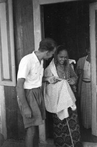 Een Indonesische vrouw krijgt nieuwe kleding stuk stof van een Europese man, Bestanddeelnr 52-1-2