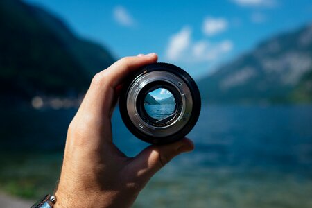 Focusing hand holding lens photography