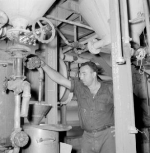 Fabriek voor kunstmest Plantex bij Haifa Arbeider bij een machine aan het werk, Bestanddeelnr 255-4400