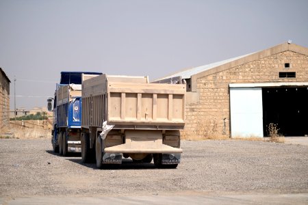 Ezidi workers and administrators packing grain in summer of 2019 at the grain processing center in Shingal 41
