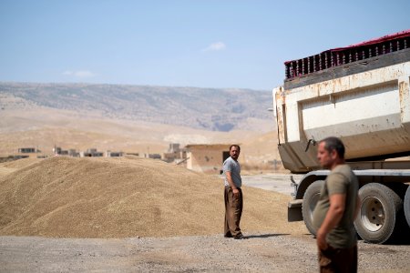 Ezidi workers and administrators packing grain in summer of 2019 at the grain processing center in Shingal 37