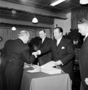 Fabrieksdirecteur Jan van Abbe (rechts) schudt hand van een man, Bestanddeelnr 255-8563
