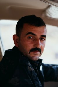 Ezidi man drives through a crossroads near Sinjar town where Ezidis were massacred, now an Iraqi police checkpoint 07