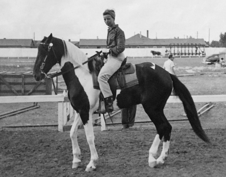 Eva Ring riding Paint horse on race track