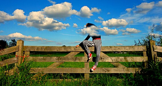 Fence woman sitting on a fence fashion