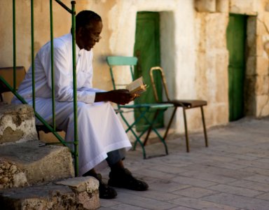 Ethopian Quarter man reading Jerusalem Victor 2011 -1-31 photo