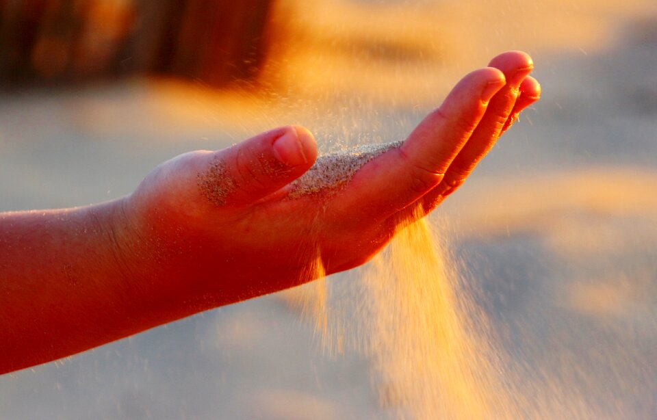 Sand rippling sand sand trickling through fingers