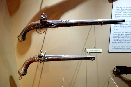 Flintlock pistols, top Algeria, early 19th century, wood inlaid with silver and coral, bottom India, Mughal dynasty, 18th or 19th century, silver and wood inlaid with gold - Huntington Museum of Art - DSC04932