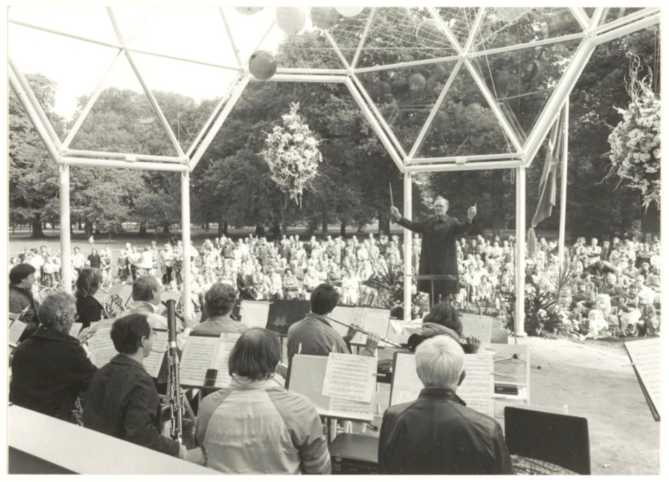 Feestelijke opening van het Muziekpaviljoen in Den Hout. Burgemeester Reehorst als dirigent van de Haarlemse Harmonie Kapel en het Noordhollands Philharmonisch Orkest, NL-HlmNHA 54016547