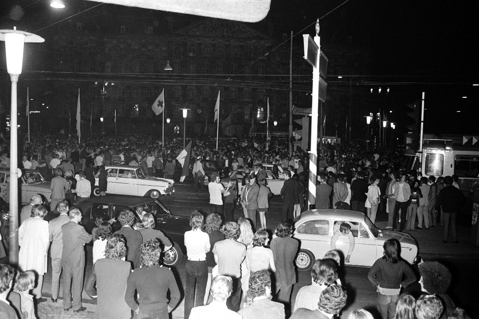 Feestende mensen op de Dam, op de achtergrond het Paleis op de Dam, Bestanddeelnr 924-6118
