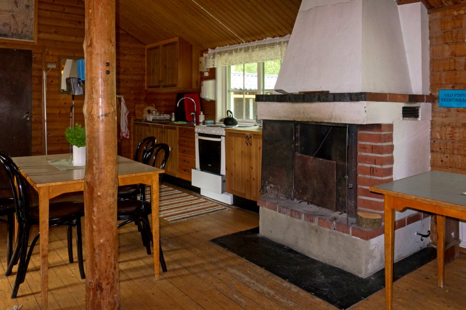 Fjällastugan kitchen area and fireplace