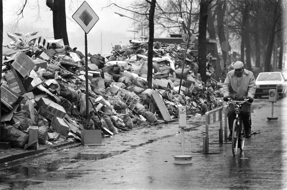 Fietser rijdt langs de afvalbergen, Bestanddeelnr 932-7884