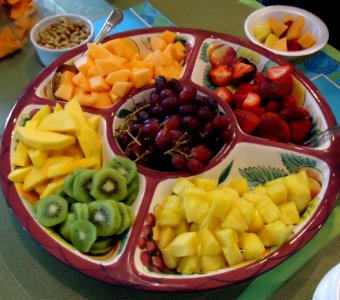 Fruit platter at a party with kiwi melons strawberries etc photo