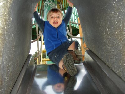 Slide happy kid outdoors photo