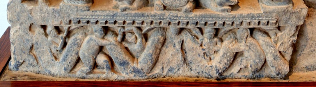 Garland bearers in Preaching Buddha, perhaps the Great Miracle of Sravasti, Gandhara, c. 3rd century AD, gray schist - Matsuoka Museum of Art - Tokyo, Japan