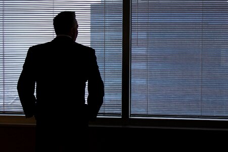 Businessman window looking out window